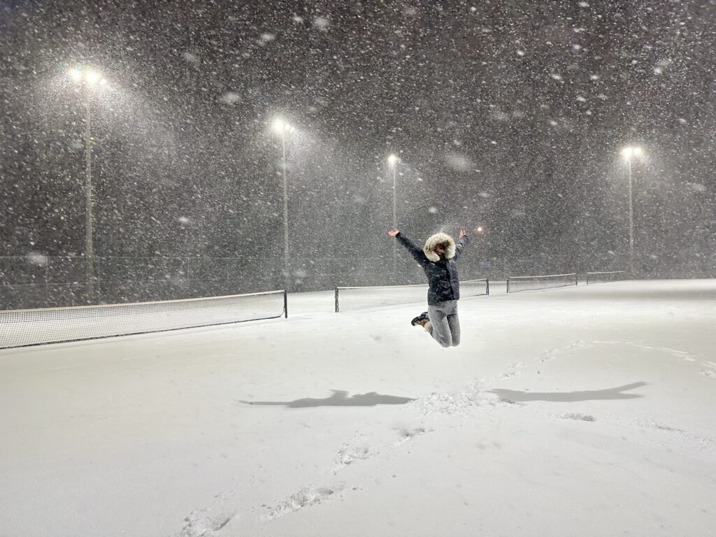 Person in snow jumping for joy